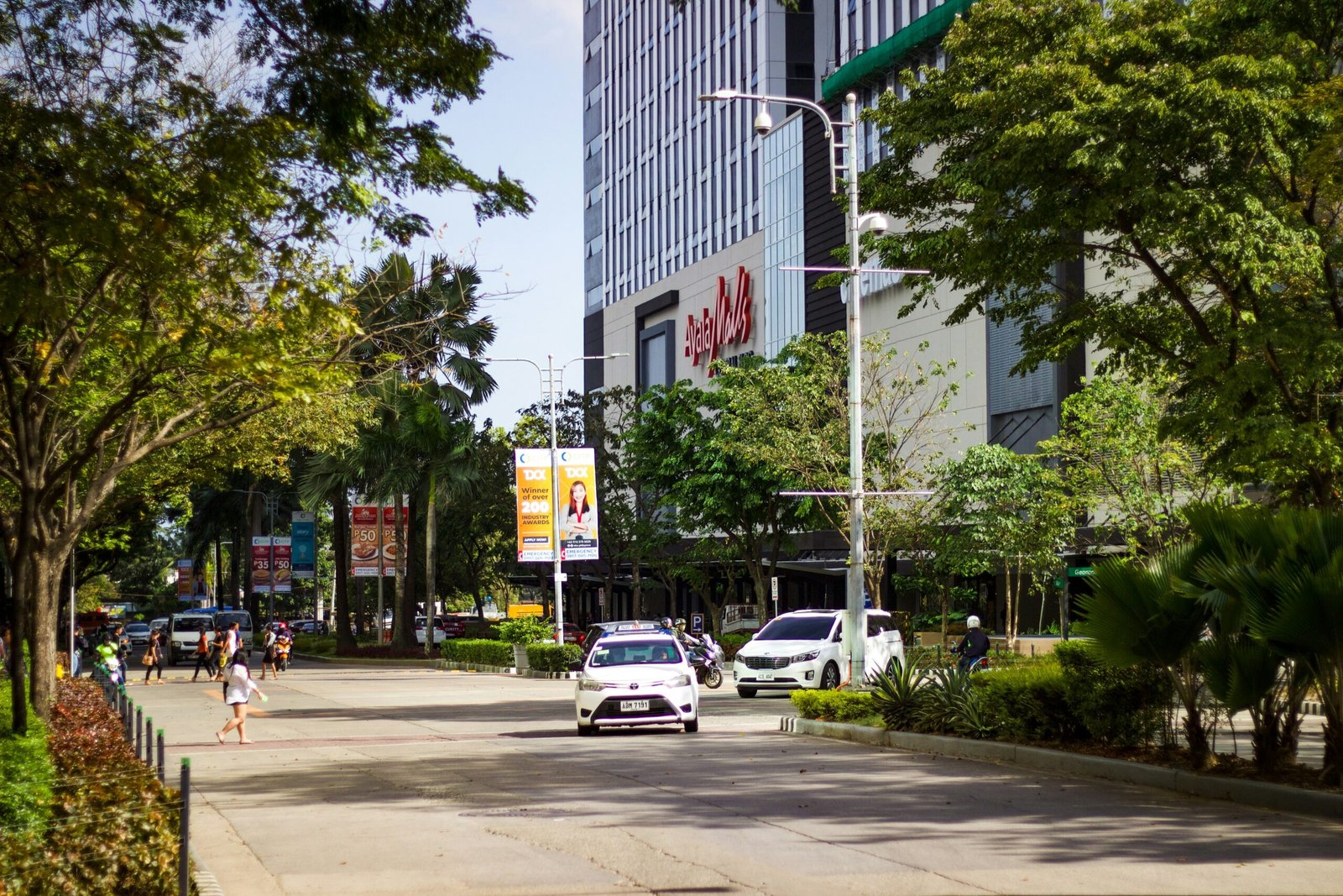 cars parked on sidewalk near building during daytime