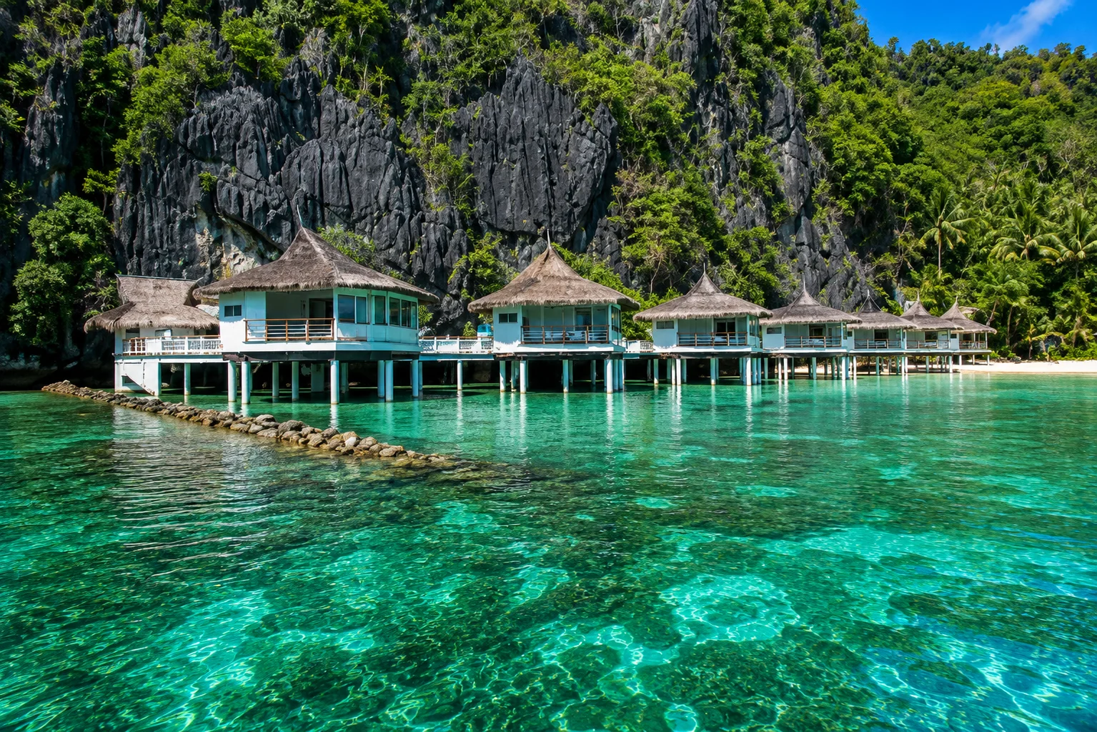 El Nido Resorts Lagen Island — water cottages on stilts over the lagoon in Palawan