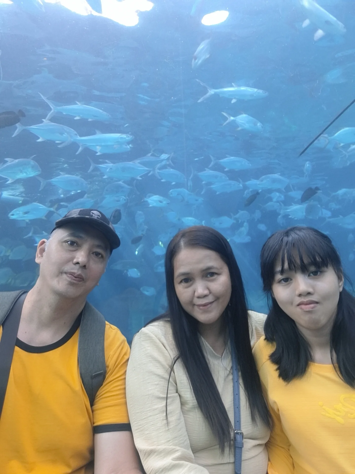 Giovanni Carlo Bagayas, wife Maybel, and daughter May Carl taking a family selfie inside the large tunnel aquarium at Cebu Ocean Park
