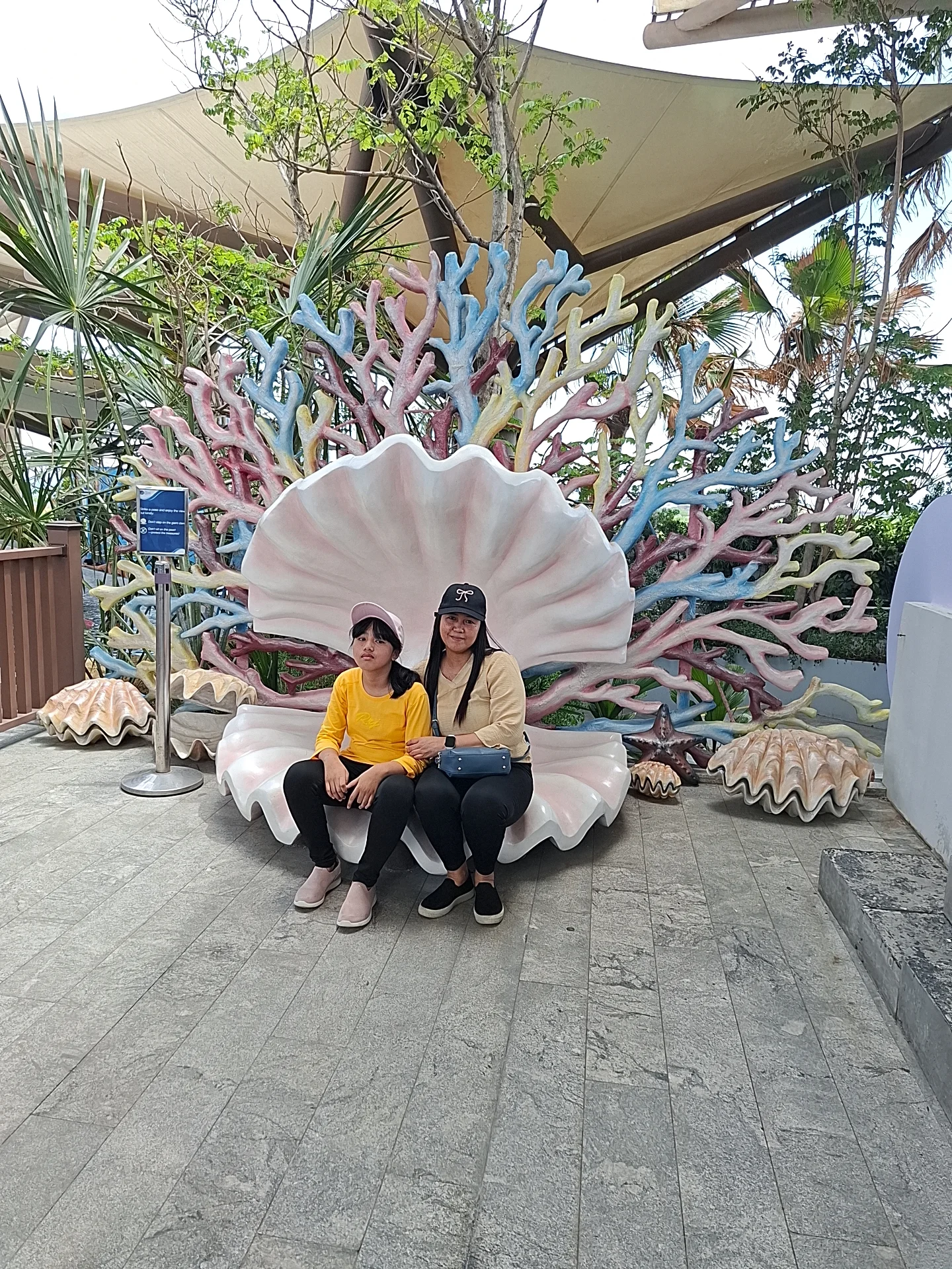Giovanni Carlo Bagayas family photo at the giant clamshell-shaped bench with coral reef backdrop at Cebu Ocean Park