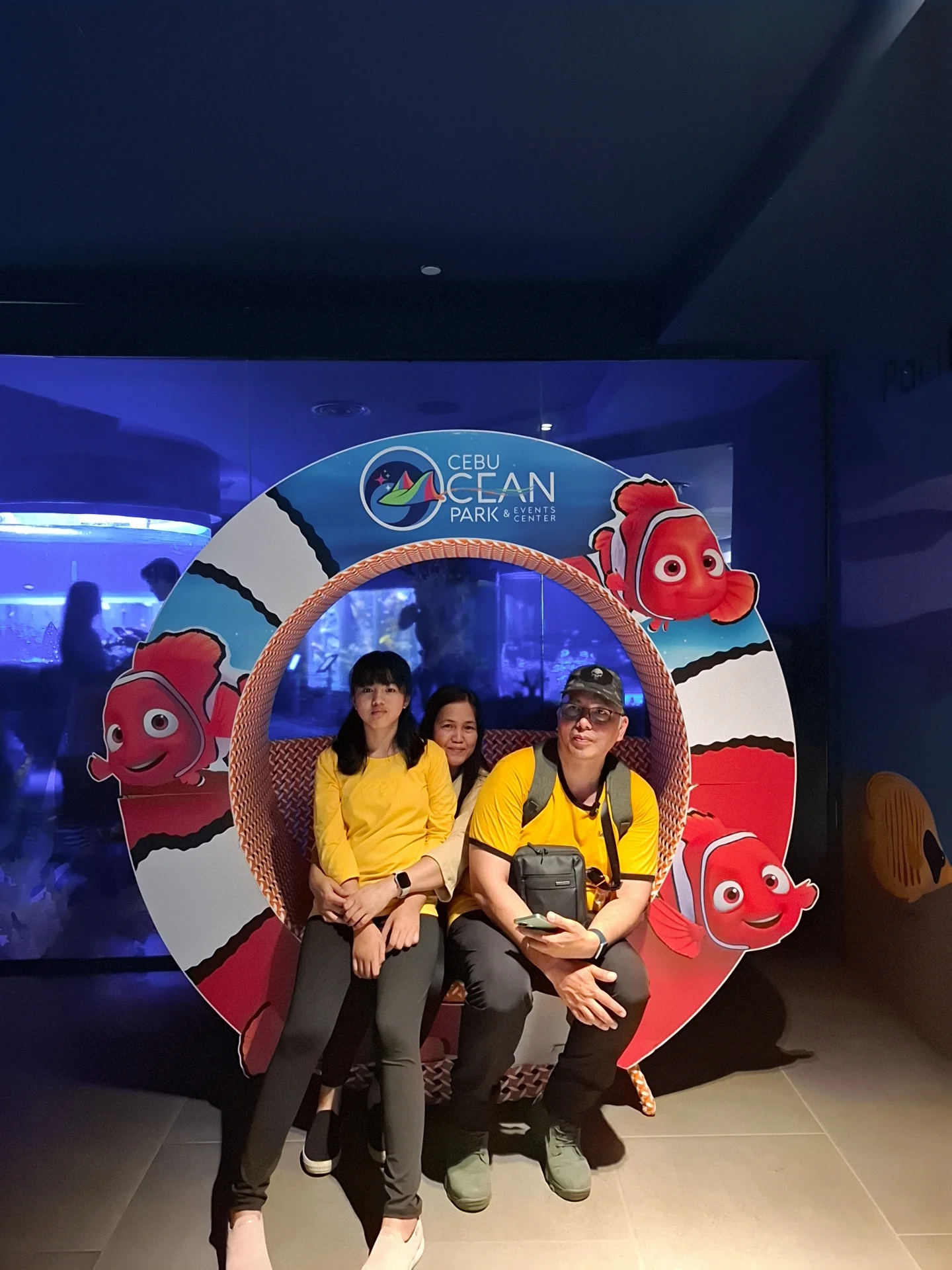 Giovanni Carlo Bagayas posing with family next to Southern Ocean zone signage in a hallway at Cebu Ocean Park