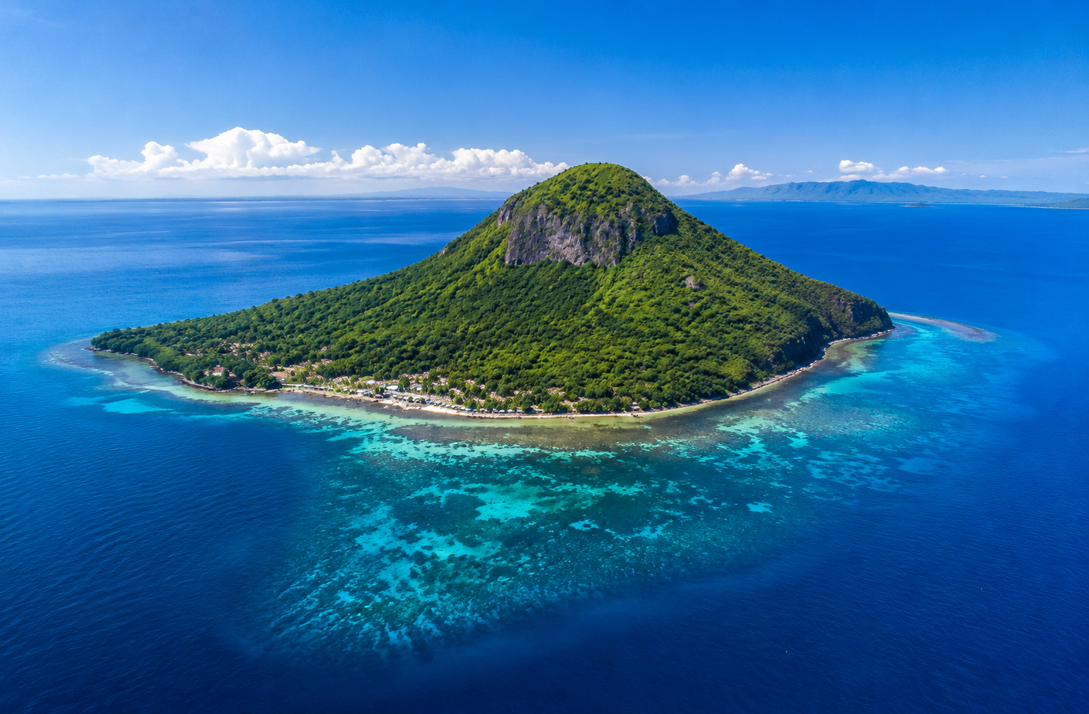 Aerial view of Apo Island Philippines — small volcanic island surrounded by turquoise water and vibrant coral reef, Negros Oriental