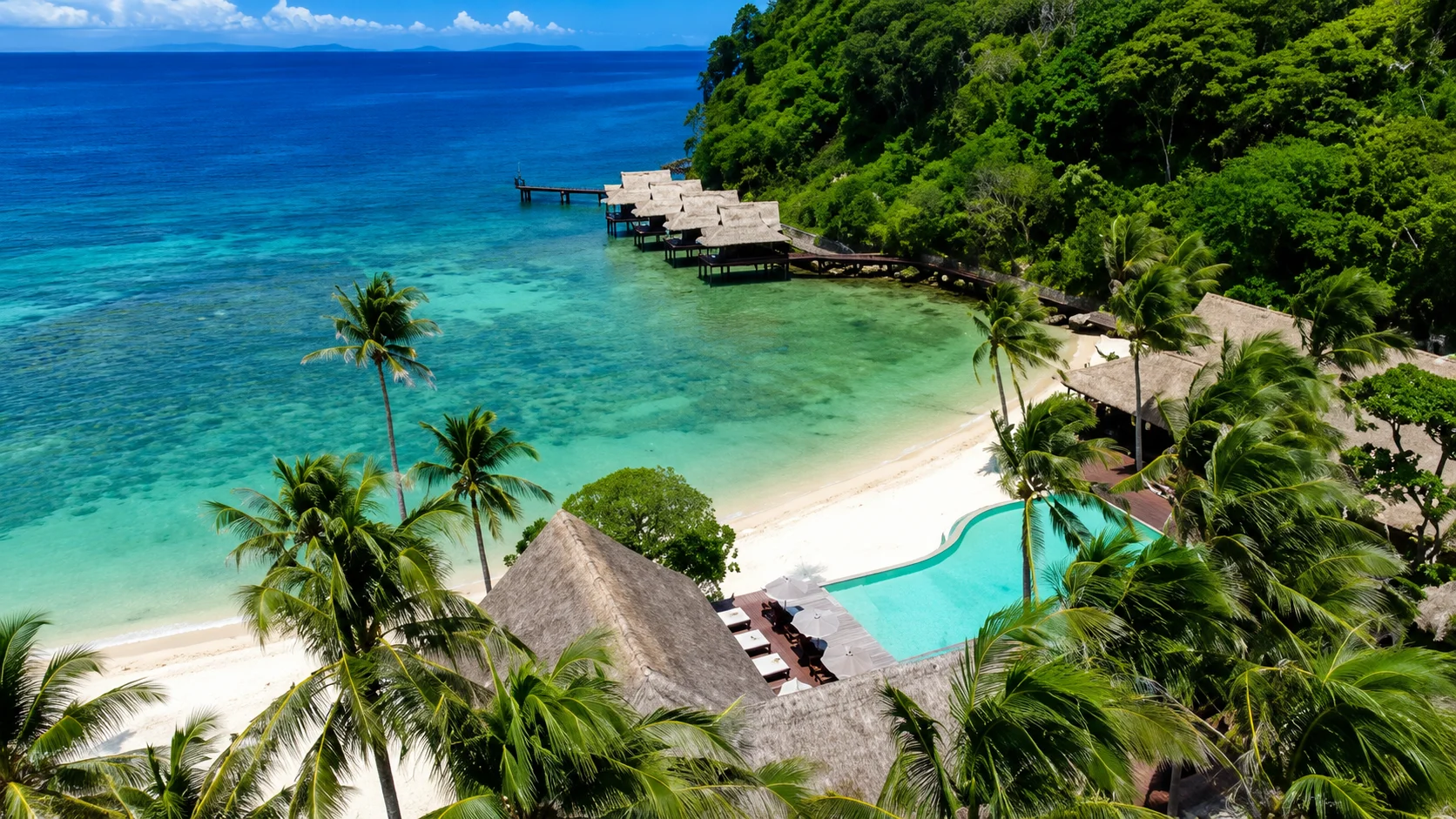 Cauayan Island Resort and Spa El Nido Palawan — crescent beach surrounded by limestone cliffs