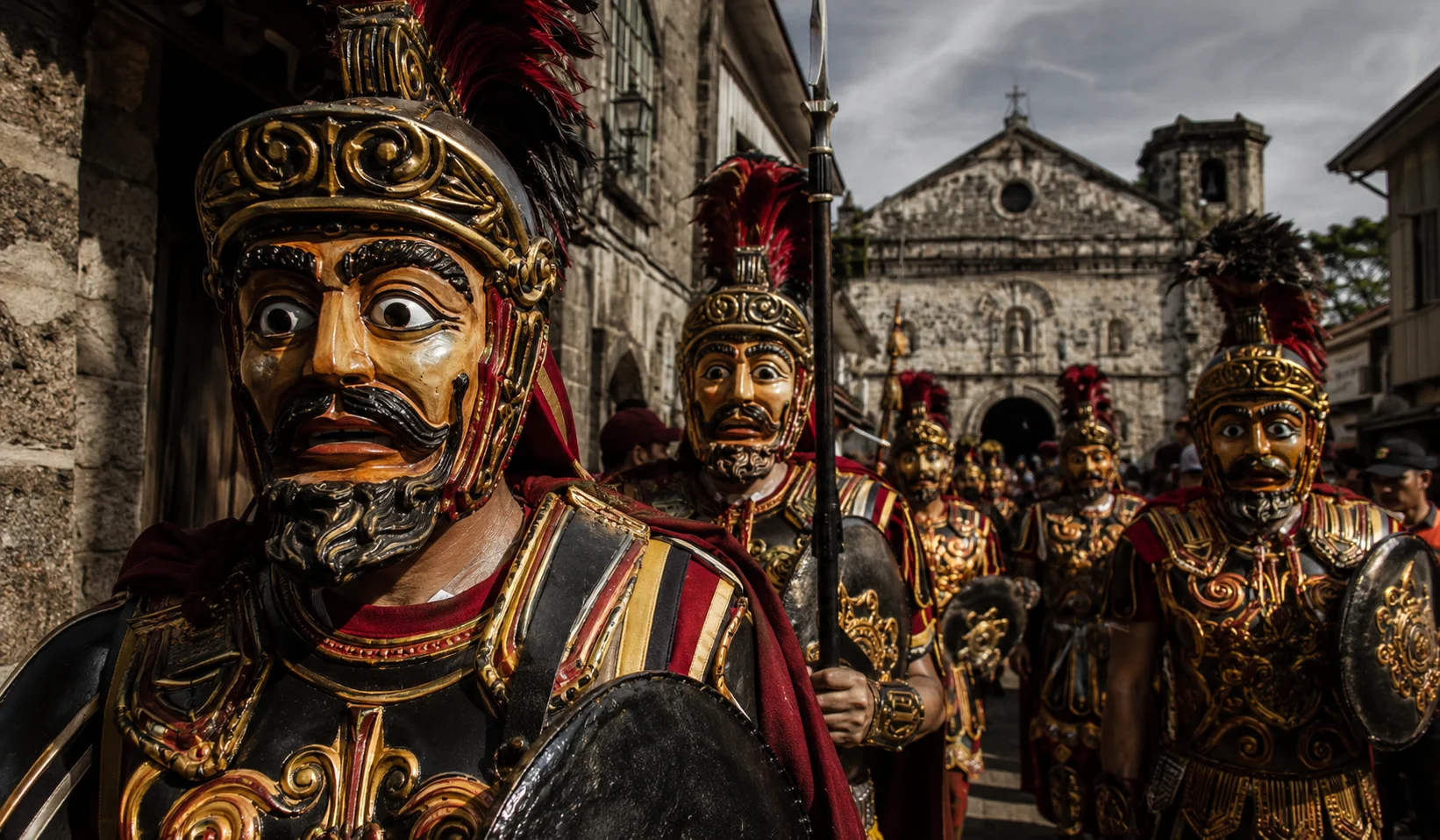 Moriones Festival Marinduque — participant dressed as a Roman soldier wearing an intricately carved wooden helmet and painted mask during Holy Week re-enactment of the story of Longinus