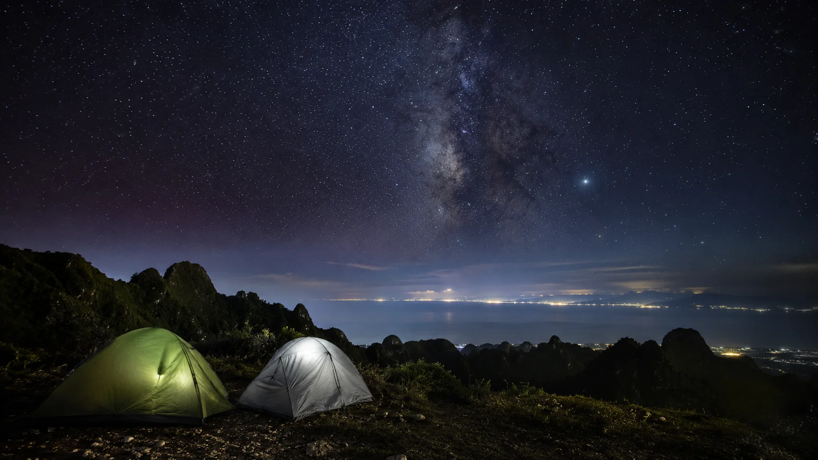 Camping at Osmena Peak Cebu Philippines — tents pitched near the summit with views of the Tañon Strait and Negros Island at night, stargazing from the highest point in Cebu at 1013 metres