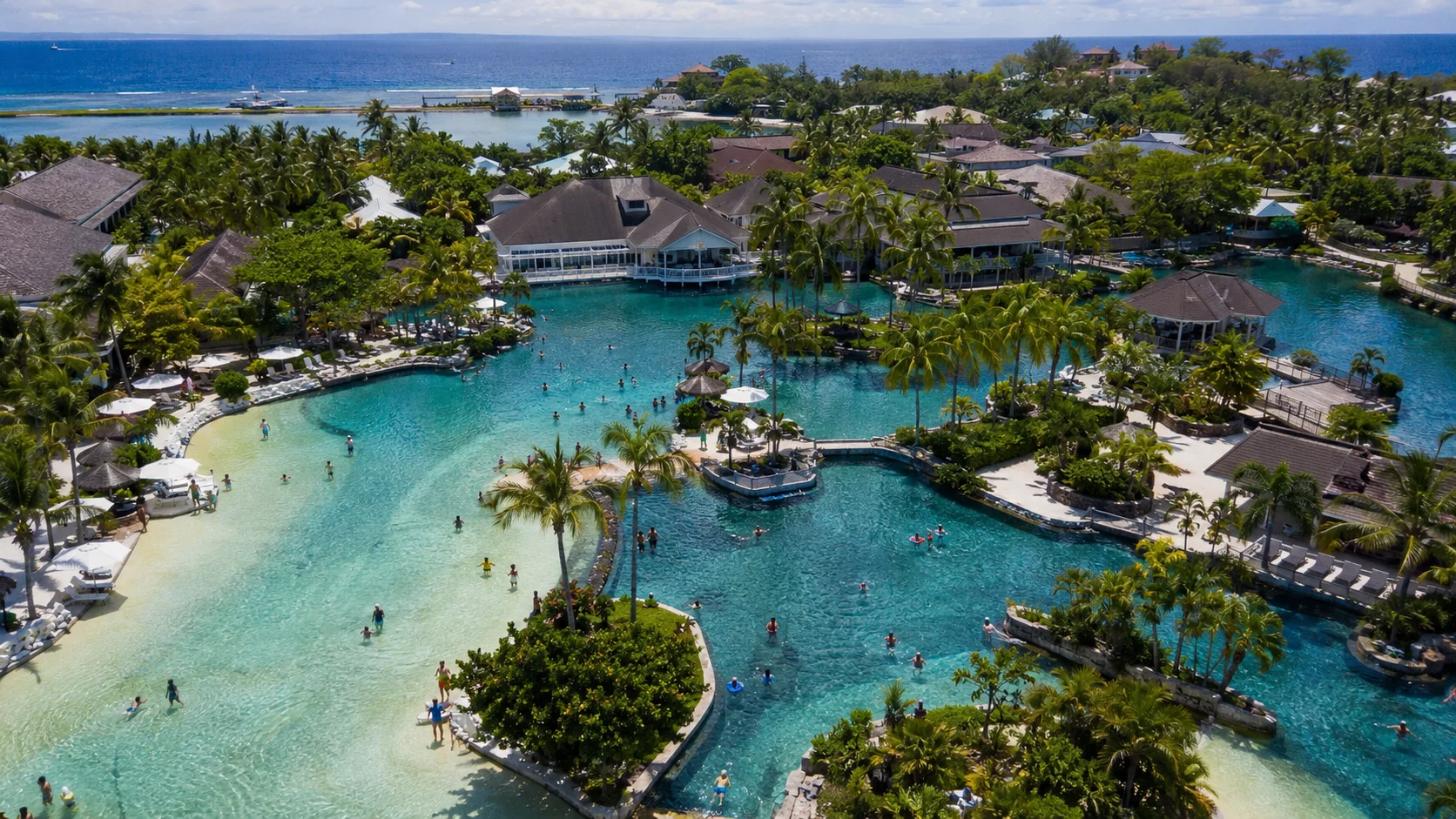 Plantation Bay Resort Mactan Cebu — sprawling lagoon complex with multiple swimming pools and private beach, one of the best resort day passes in the Philippines available on Klook