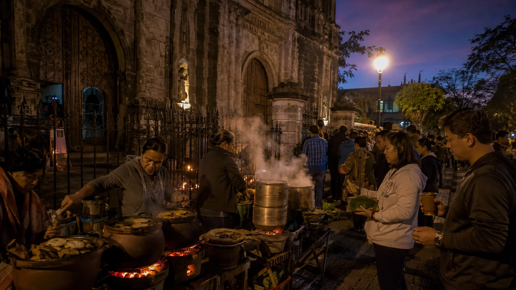 Simbang Gabi food vendors outside Philippine church at 4AM — bibingka clay pot ovens glowing orange and puto bumbong bamboo steamers with white steam, Filipino churchgoers gathering after pre-dawn mass
