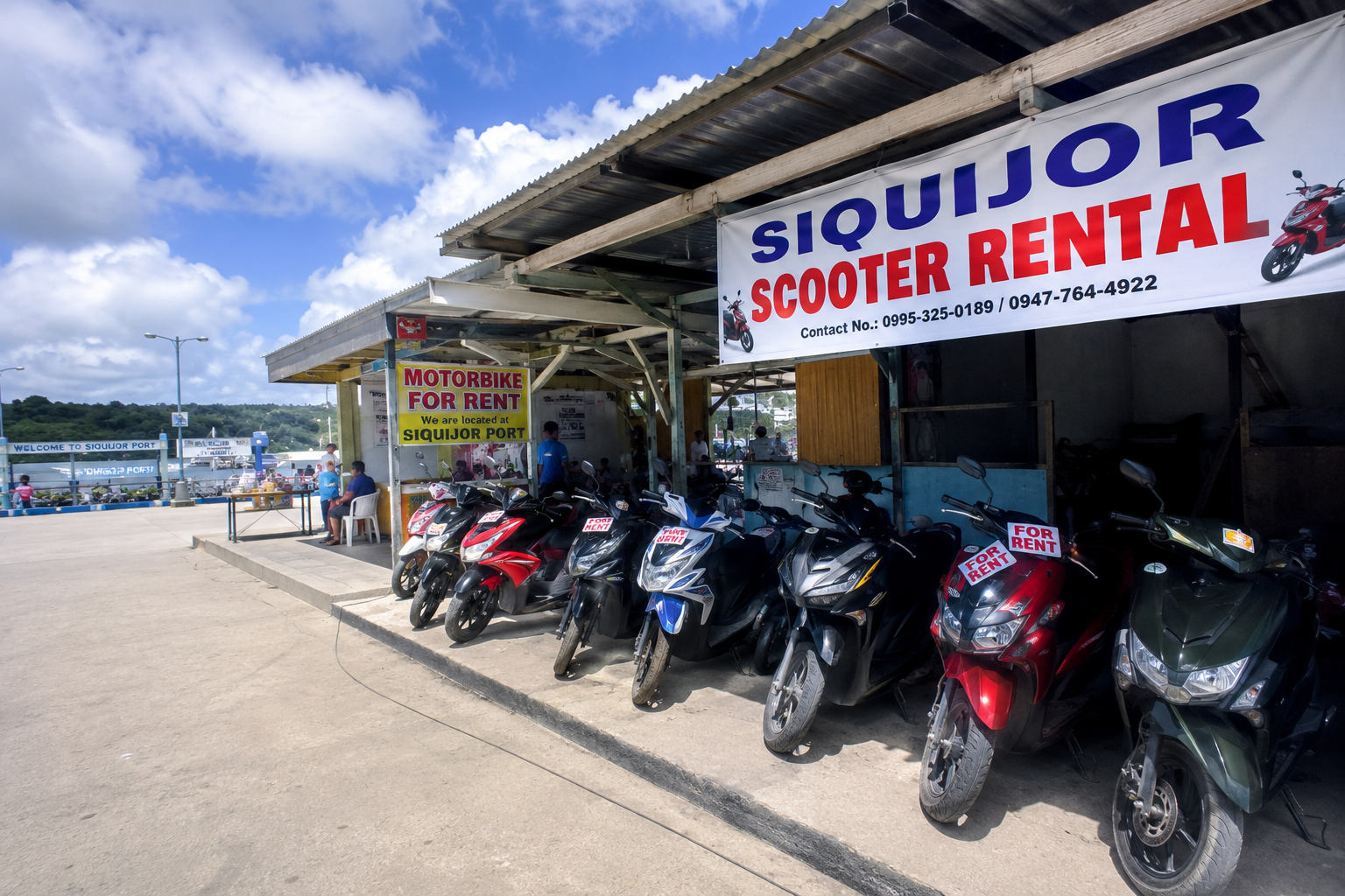 Scooter rental stalls right outside Siquijor Port on arrival — showing motorbikes available for hire at ₱300-500 per day at the pier exit Siquijor Philippines