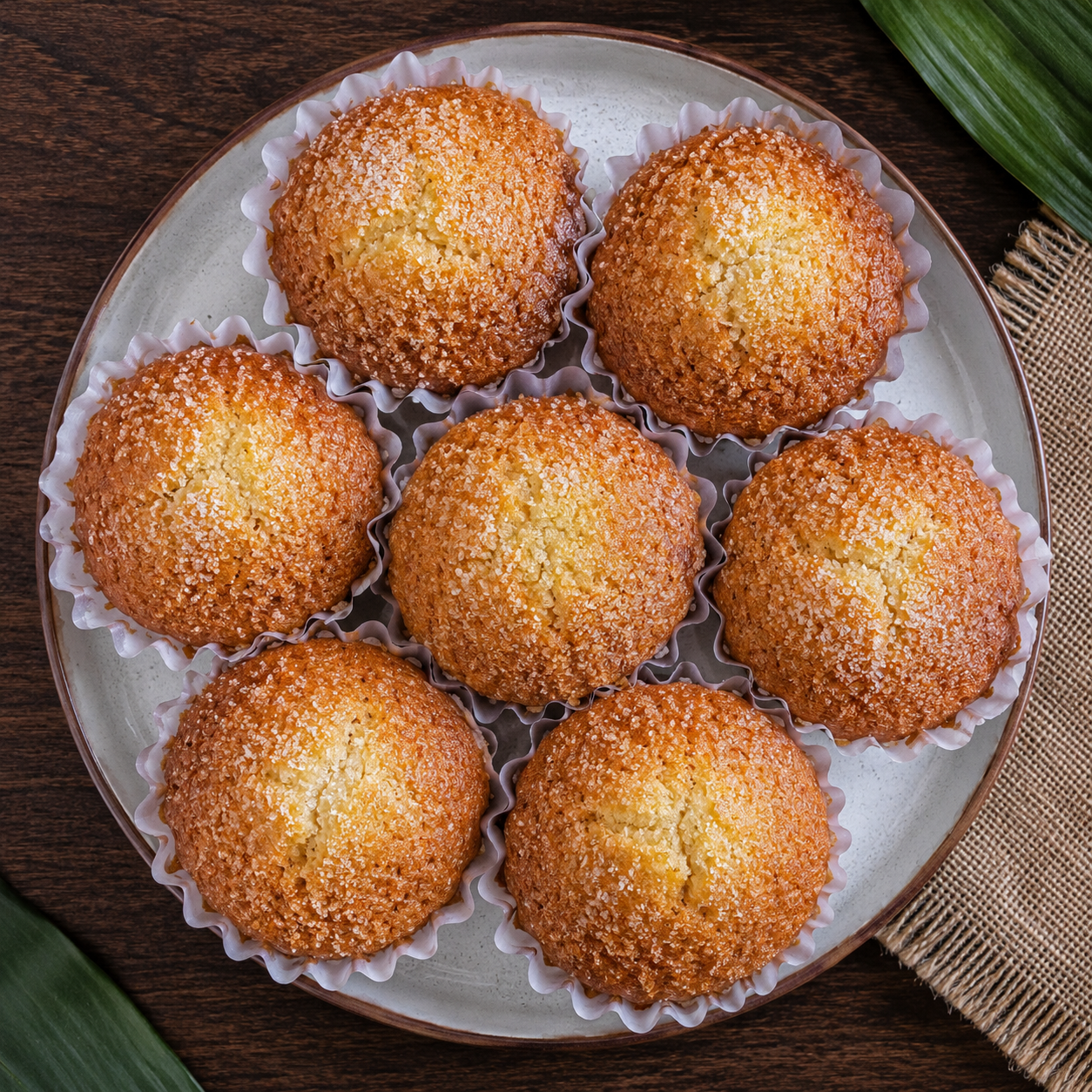 Finished homemade Torta Siquijor on a plate — top-down view showing the golden sugar-dusted surface of the traditional Filipino sponge cake