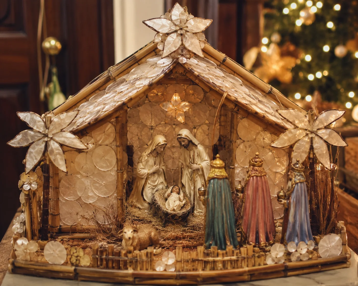 Christmas in the Philippines: Parols, Simbang Gabi & Noche Buena Explained 12 A handmade Filipino Belen nativity scene with capiz shell and bamboo details on a home entryway table