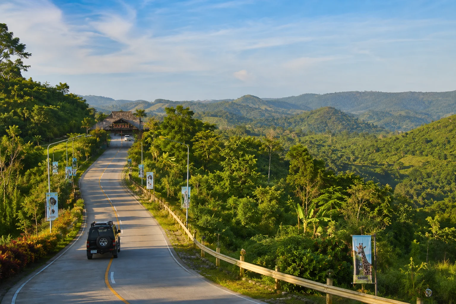 Winding mountain road leading uphill to Cebu Safari and Adventure Park in Carmen Cebu Philippines through lush tropical greenery