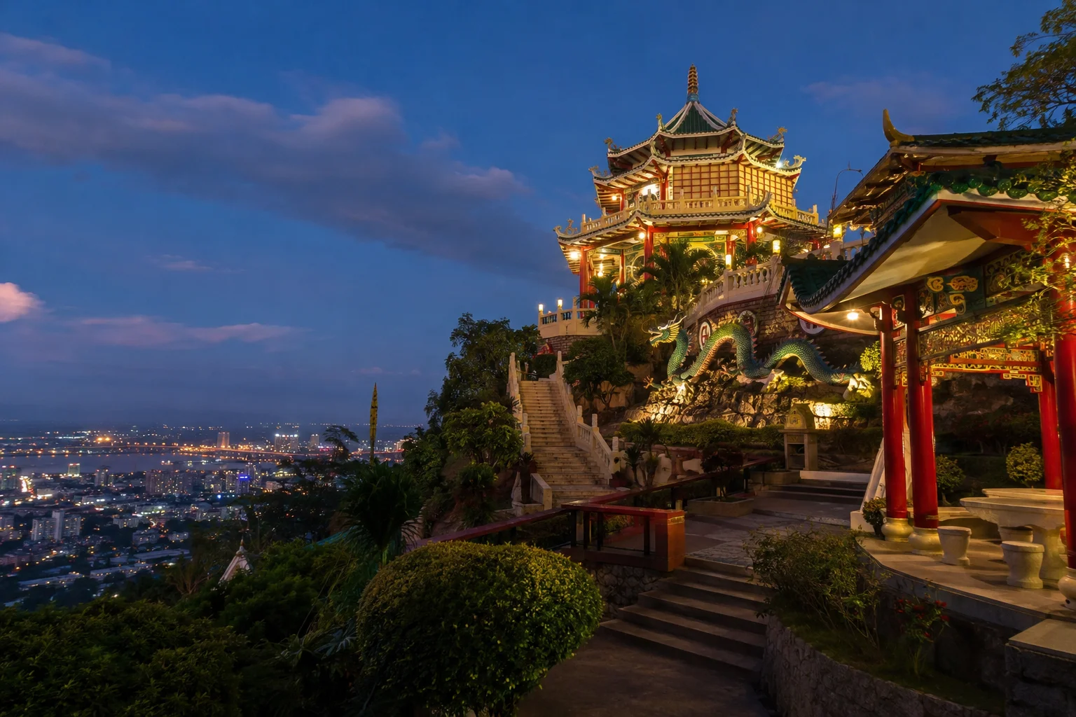 Cebu Taoist Temple illuminated at night with city view below