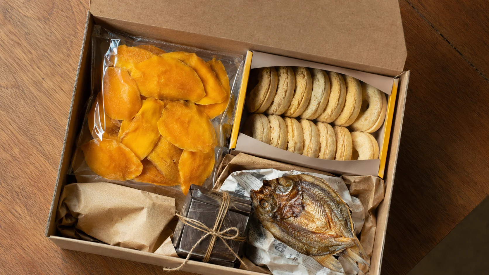 Assorted pasalubong from Cebu packed in a box including dried mango, rosquillos, and danggit