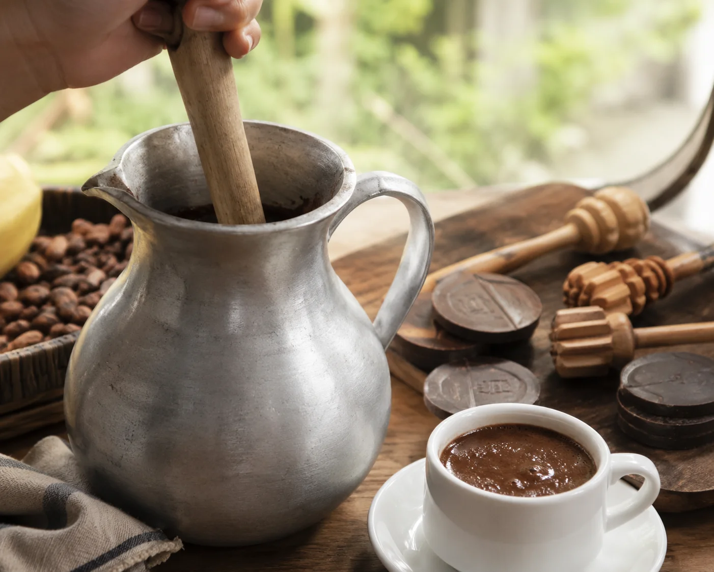 Traditional Cebuano sikwate hot chocolate being whisked with a batirol
