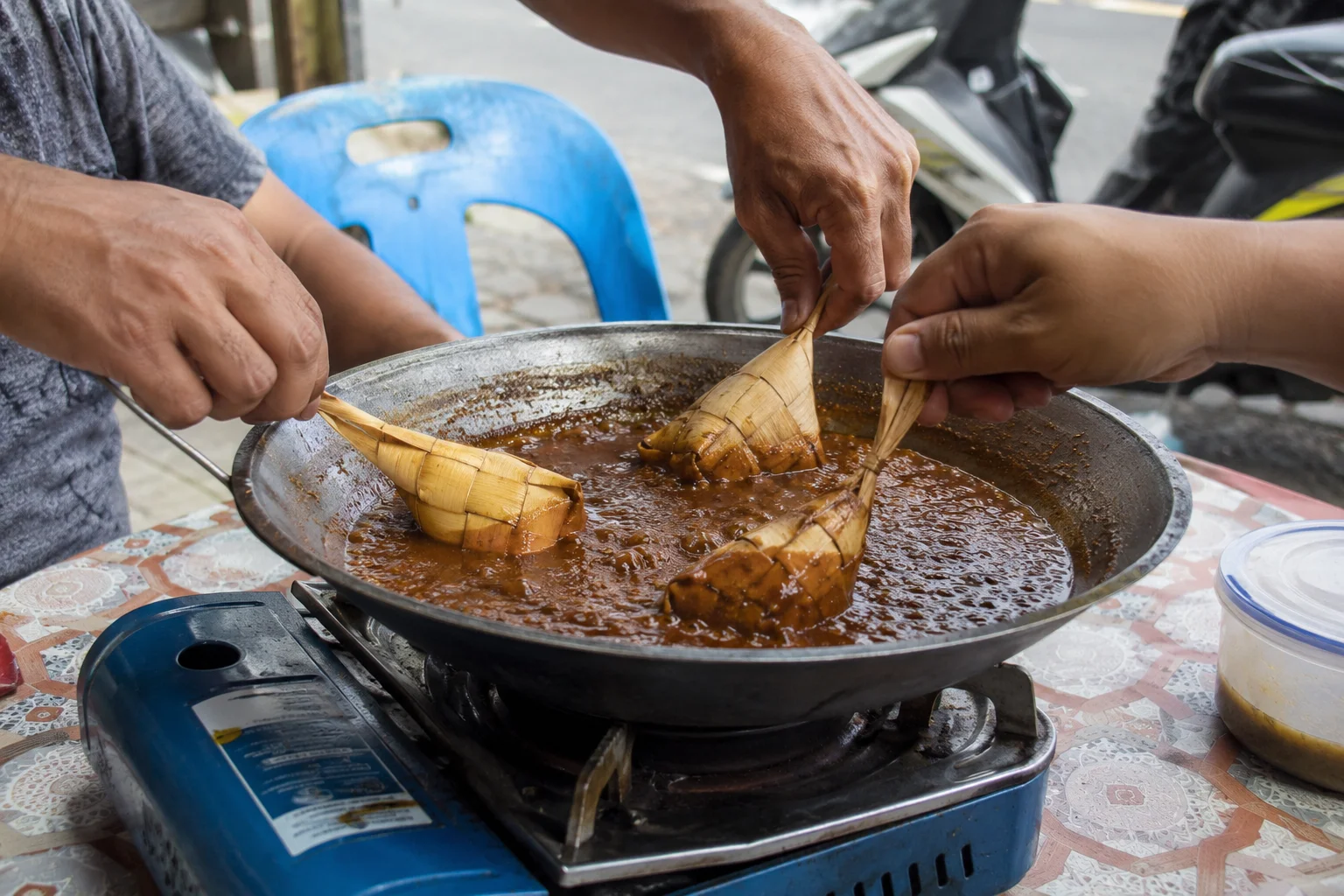 Tuslob buwa communal dish being eaten with hanging rice in Cebu