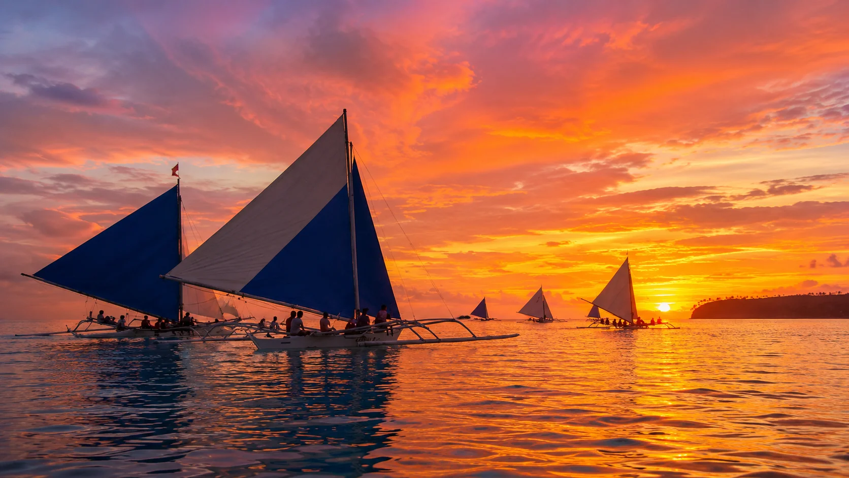 Traditional paraw sailboat sunset sailing, Boracay