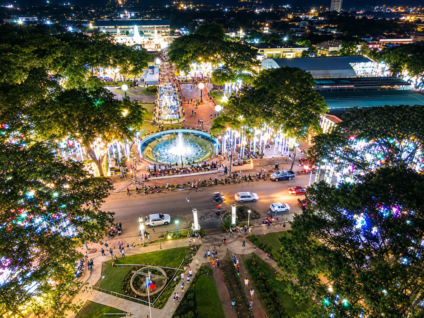 Plaza Luz Pagadian City at night — illuminated trees, dancing fountain, and the plaza promenade