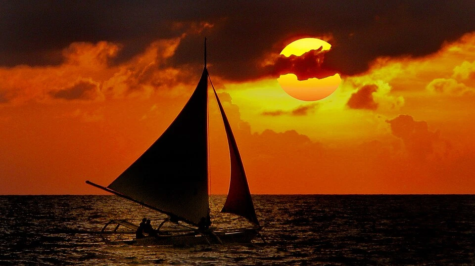 10 Romantic Getaways in the Philippines (2026): Best Honeymoon Spots for Couples 14 Paraw sailboat at sunset on White Beach, Boracay