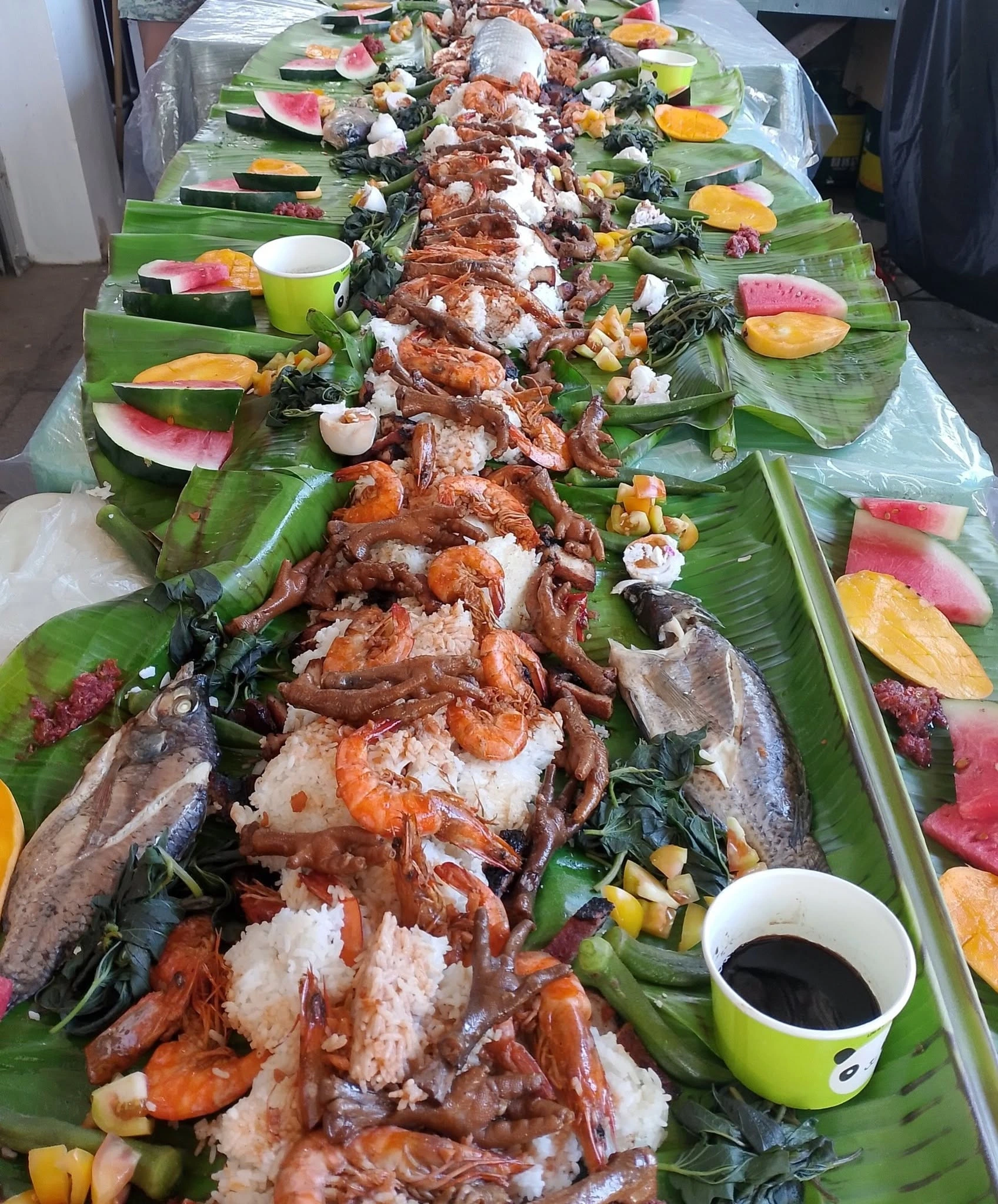 Filipino fiesta boodle fight with food laid out on banana leaves