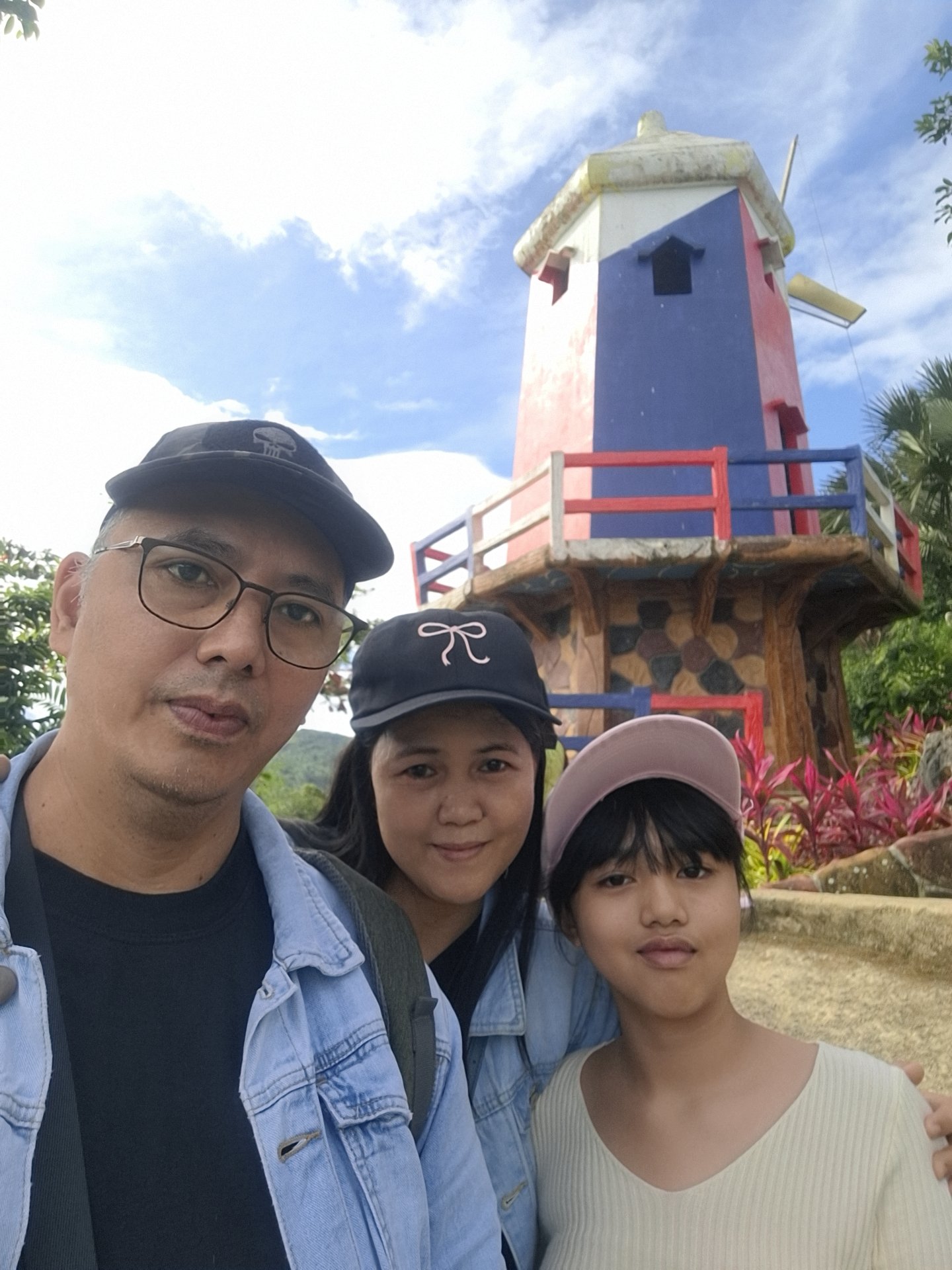 Family in front of the windmill replica at Sirao Flower Garden, Cebu’s Little Amsterdam